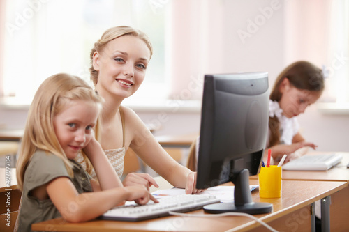 Photo: Little girl at school class Little girl at school class