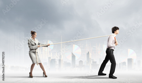 Photo: Three business people pulling rope Three business people pulling rope