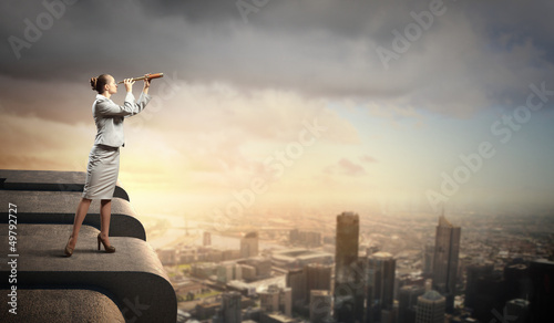 Photo: Business woman with telescope Business woman with telescope