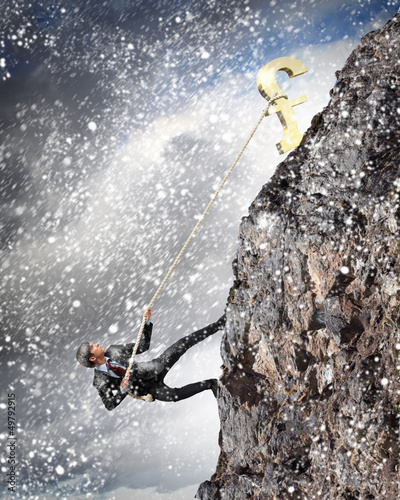Photo: busiessman climbing mountain busiessman climbing mountain