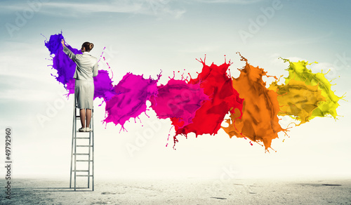 Photo: Young woman drawing splashes Young woman drawing splashes