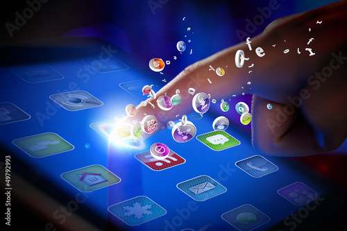 Photo: Closeup of finger touching tablet-pc screen Closeup of finger touching tablet-pc screen