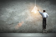 Business man drawing lamp