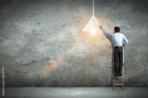 Photo: Business man drawing lamp Business man drawing lamp