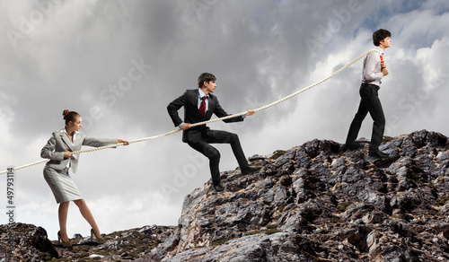 Photo: Three business people pulling rope Three business people pulling rope
