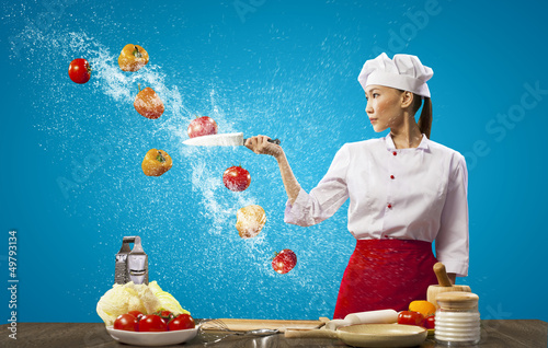 Photo: Asian female cook with knife Asian female cook with knife