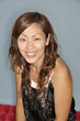 Head and shoulders of a smiling Asian woman