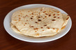 Stack of flour tortillas on plate