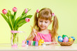 cute kid girl painting Easter eggs