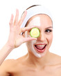 Young woman with clay facial mask, isolated on white