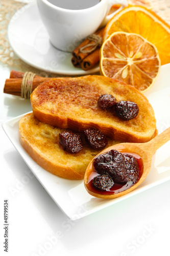 Photo: White bread toast with jam and cup of coffee, isolated on white White bread toast with jam and cup of coffee, isolated on white