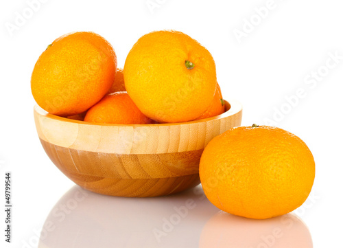 Photo: Tasty mandarines in wooden bowl isolated on white Tasty mandarines in wooden bowl isolated on white