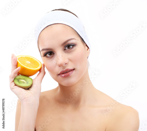 Photo: Young woman with fruit.Concept: Facial fruit masks. Isolated Young woman with fruit.Concept: Facial fruit masks. Isolated