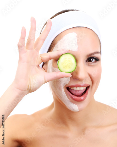 Photo: Young woman with clay facial mask, isolated on white Young woman with clay facial mask, isolated on white