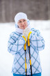 Beauty woman warming frozen hands with ski poles in winter