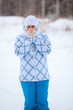 Happy woman portrait with warming frozen hands in winter