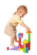 Photo: Baby girl building from toy blocks. Baby girl building from toy blocks.