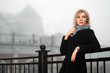 Young woman in autumn foggy morning