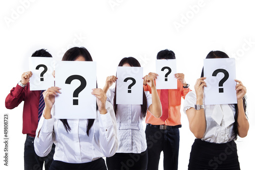 Photo: Colleagues holding question mark signs in front of their faces Colleagues holding question mark signs in front of their faces