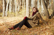 Young blond woman in autumn forest