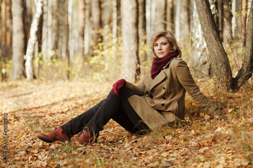 Photo: Young blond woman in autumn forest Young blond woman in autumn forest