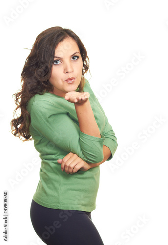Photo: Attractive girl in a green shirt blowing a kiss at you. Attractive girl in a green shirt blowing a kiss at you.