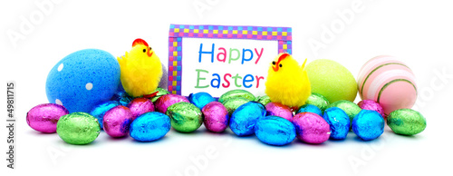 Photo: Pile of colorful eggs, candy and toys with Happy Easter card Pile of colorful eggs, candy and toys with Happy Easter card