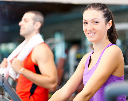 Photo: People running on treadmills in a gym People running on treadmills in a gym