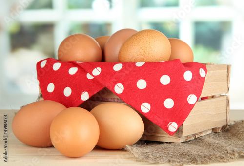 Photo: Many eggs in box on table in room Many eggs in box on table in room