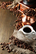 Cup of coffee, pot and grinder on wooden background