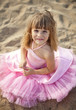 Photo: Beautiful little girl in a pink dress walking Beautiful little girl in a pink dress walking