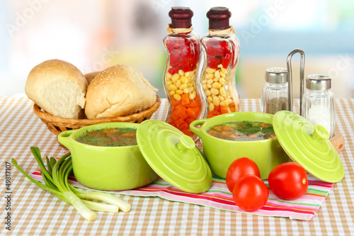 Photo: Fragrant soup in pans on table in kitchen Fragrant soup in pans on table in kitchen