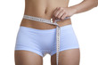 Woman measuring her waist