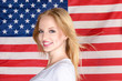 Photo: Young blonde girl posing against american flag Young blonde girl posing against american flag
