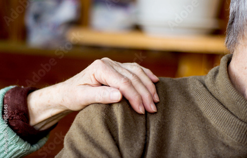 Photo: woman's hand on man's shoulder woman's hand on man's shoulder