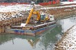 bulldozer Digger in a barge during the work of the River