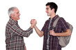 Mature man and young man handshaking