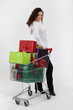 Woman with trolley full of Christmas presents