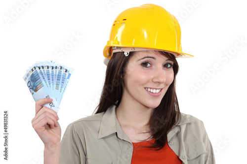 Photo: Young handy woman holding wage Young handy woman holding wage