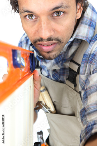 Photo: Tradesman using a bubble level Tradesman using a bubble level