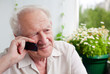 Pensive Senior Man With a Phone