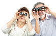 Elderly couple looks through binoculars