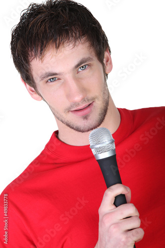 Photo: Man holding microphone Man holding microphone
