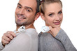 Couple with electrical plug stood back to back