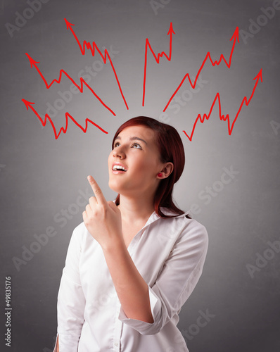 Photo: Young woman thinking with arrows overhead Young woman thinking with arrows overhead