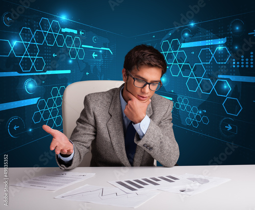 Photo: Businessman doing paperwork with futuristic background Businessman doing paperwork with futuristic background
