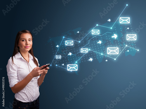 Photo: Young lady holding a phone with arrows and message icons Young lady holding a phone with arrows and message icons