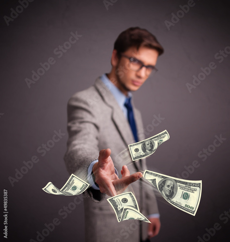 Photo: Young man throwing money Young man throwing money