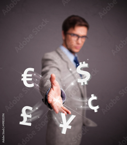 Photo: Attractive man throwing currency icons Attractive man throwing currency icons