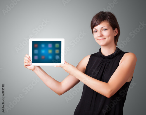 Photo: woman holding modern tablet with colorful icons woman holding modern tablet with colorful icons